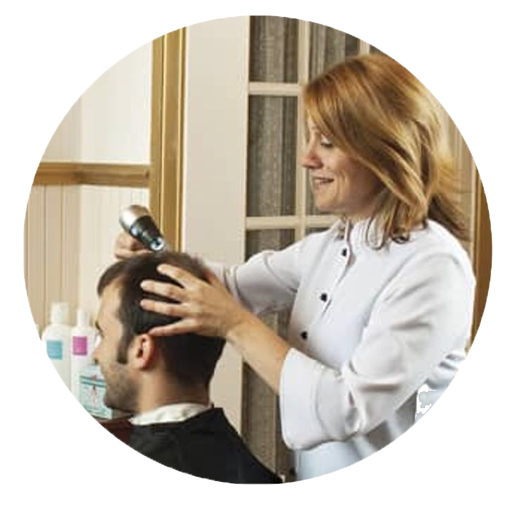 Hairdresser styling a client’s hair with clippers in a salon